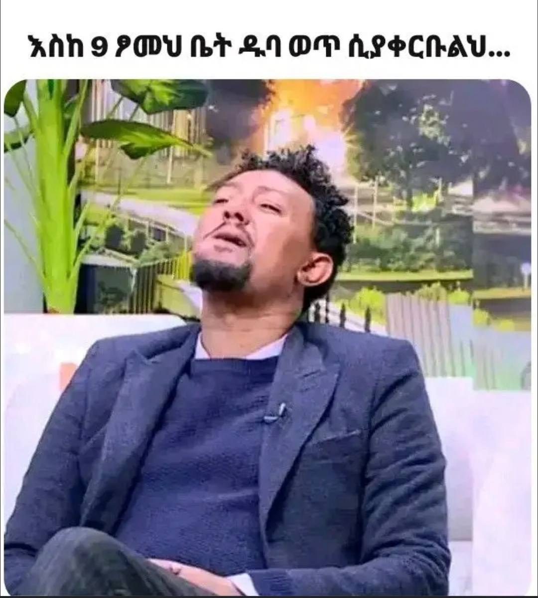 a man in a suit sitting on a couch